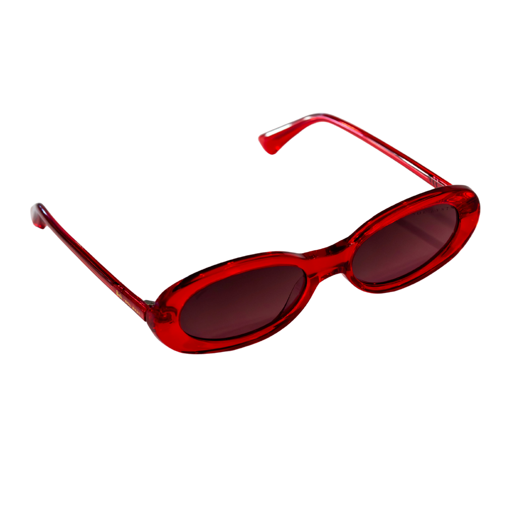 Side angle of Barbie x Sol Kyst oval sunglasses with tinted lenses and sleek red frame design