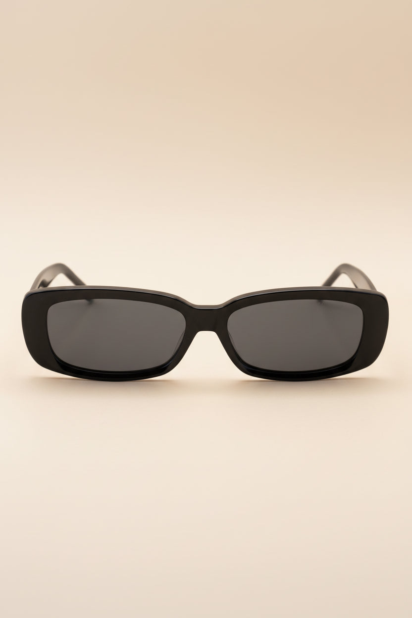 Black sunglasses with dark lenses on a white background