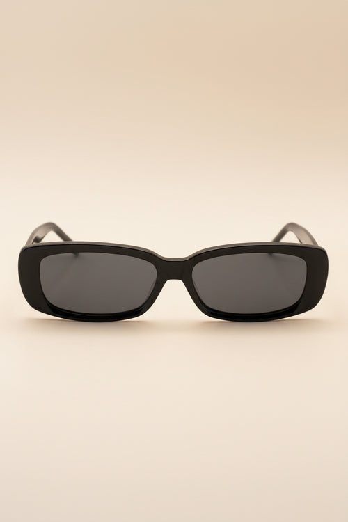 Black sunglasses with dark lenses on a white background