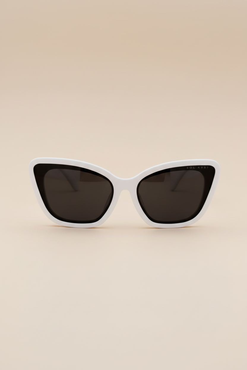 Close-up view of Sol Kyst Bridal Collection sunglasses featuring a white acetate frame and soft square cat-eye design with brown lenses.