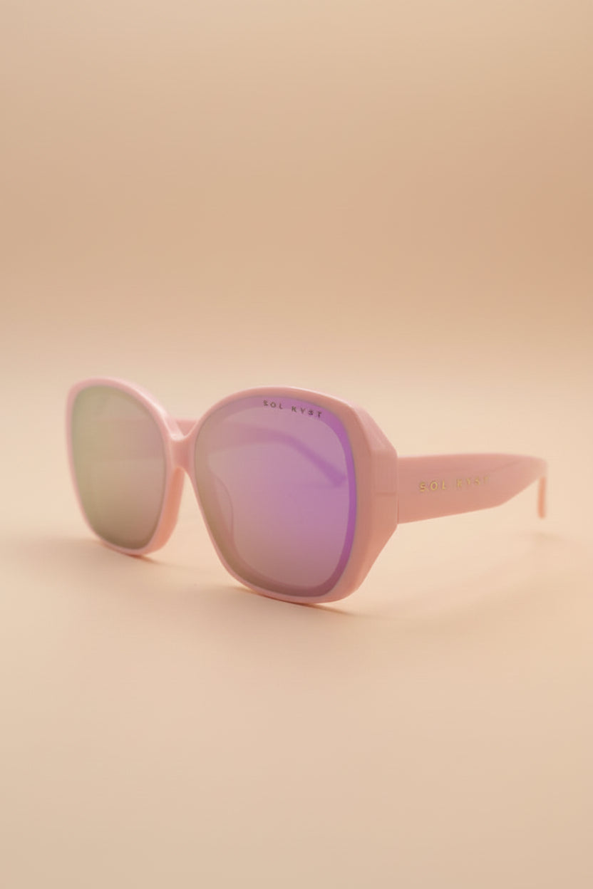 Pink sunglasses with gradient lenses on a light gray background