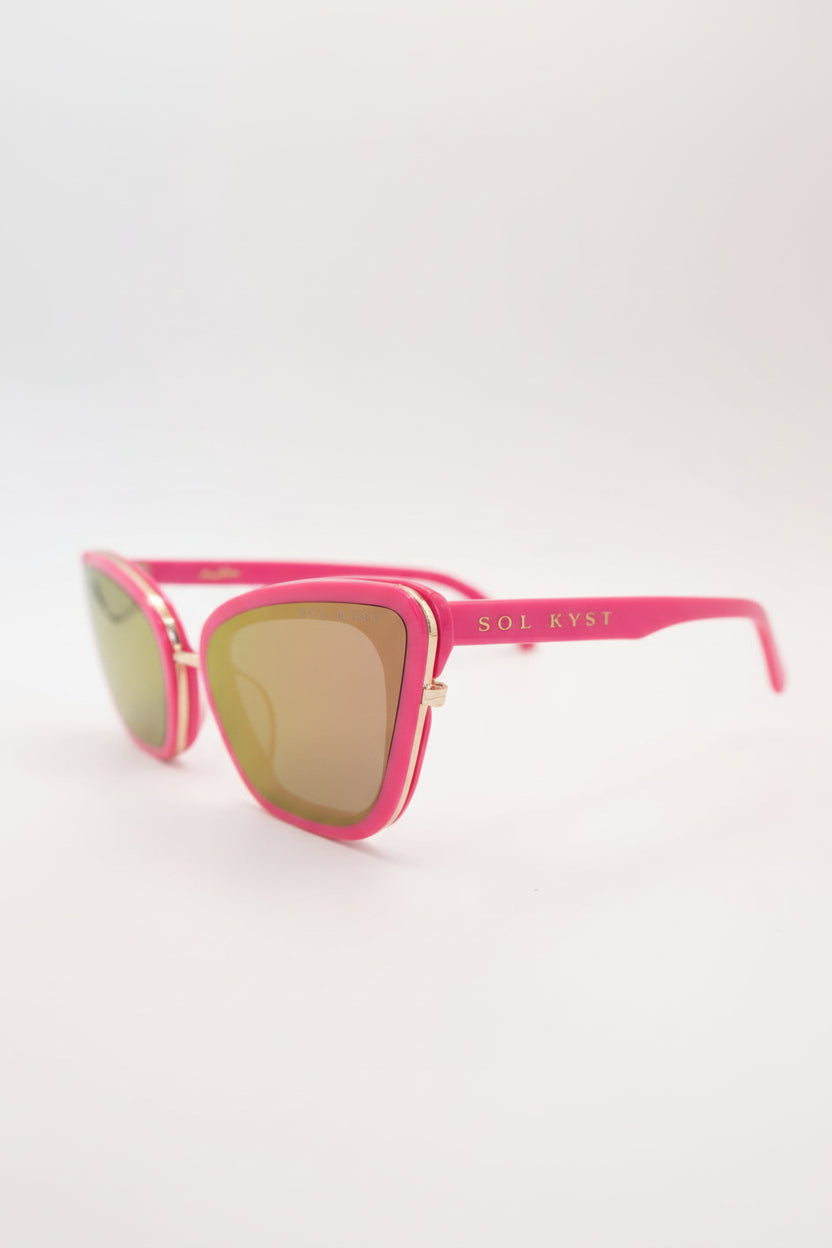 Pink sunglasses with gold lenses on a white background